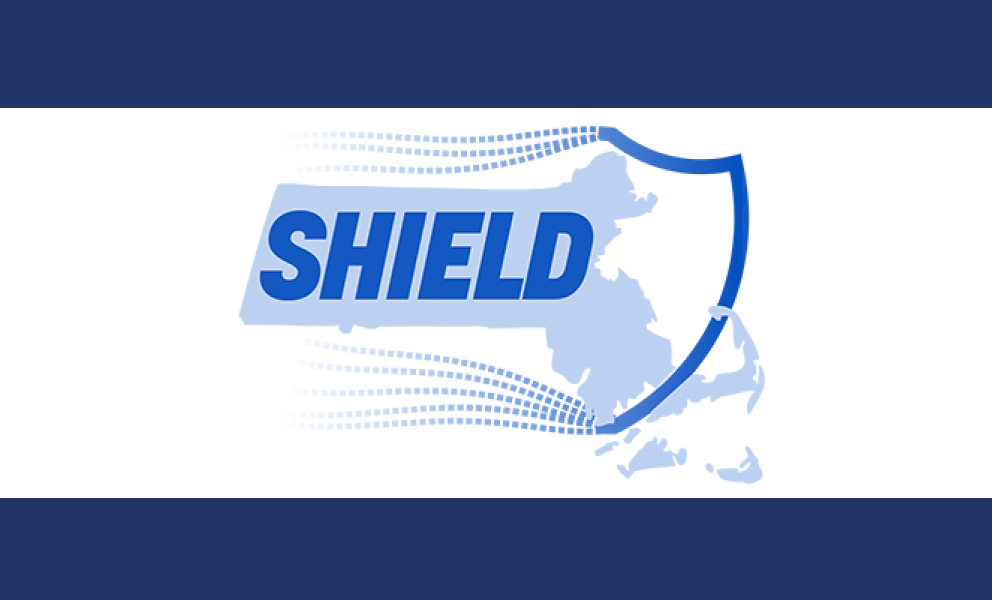 Image of a shield with the state of Massachusetts outline with letters spelling Shield